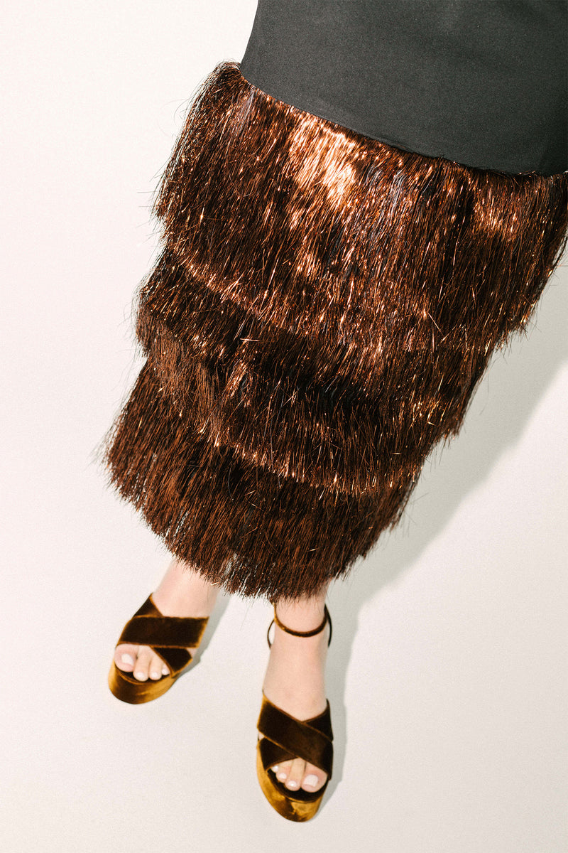 Effortless elegance in a fun, high-end style: Black & Bronze Metallic Fringe Francie Maxi Dress with classic metallic fringe, styled with chunky-heeled golden-brown velvet platform sandals.