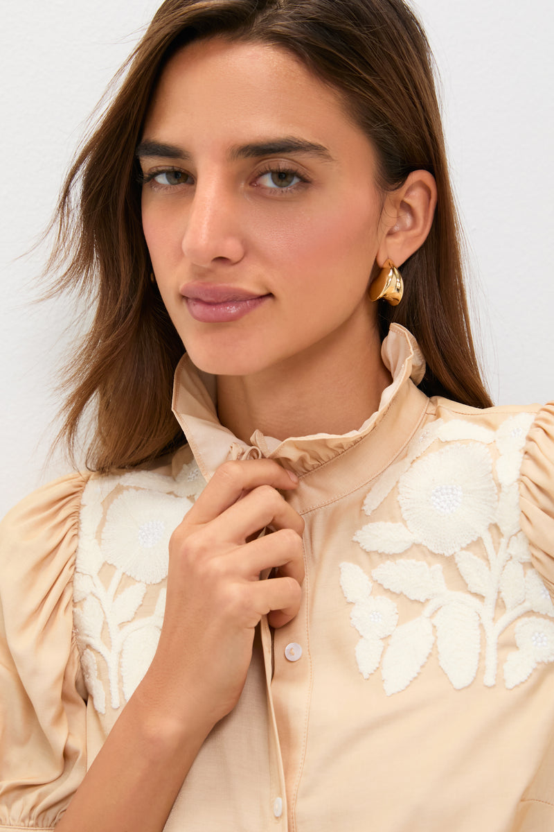 Young woman in a classic, high-end Tan & Cream Embroidery Louisa Blouse with a ruffled collar and floral embroidery, exuding effortless, fun elegance.