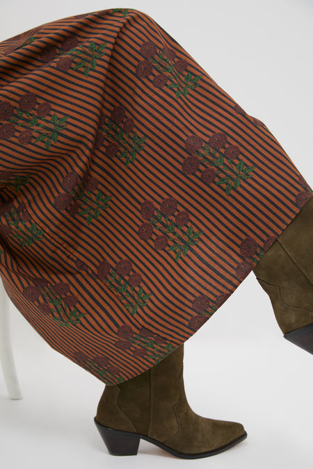 Effortlessly cool Multi Maribel Maxi Dress features a classic striped floral block print, paired with olive-green suede cowboy-style ankle boots for a fun, high-end look.