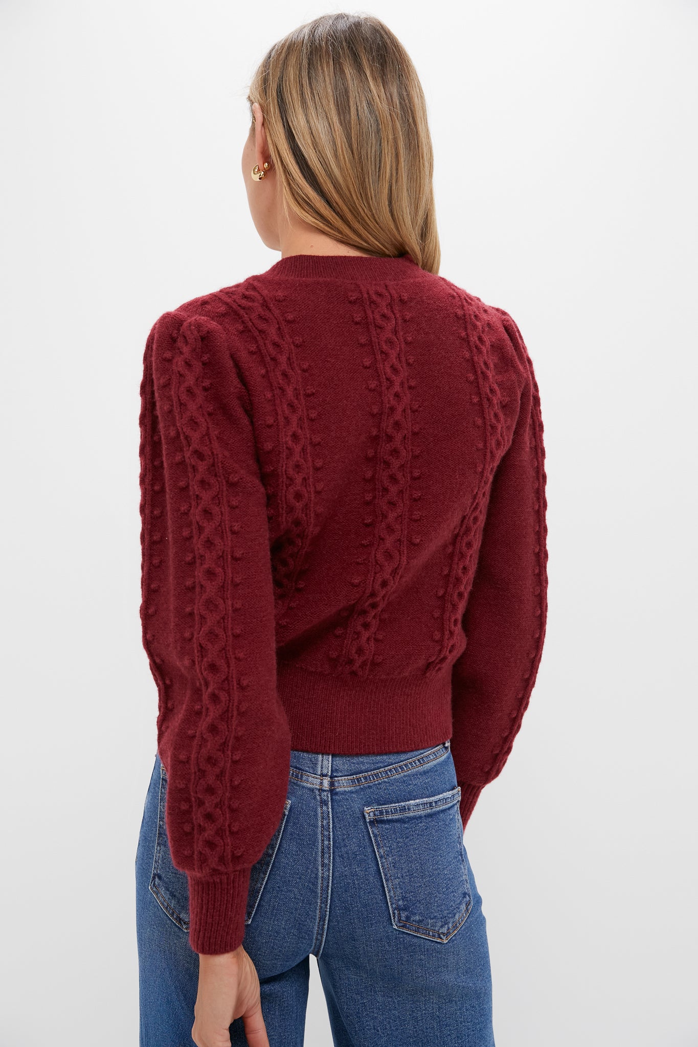 The Merlot Embroidered Floral Frankie Sweater exudes classic charm with its bobble-and-cable texture and puffed sleeves, effortlessly paired with jeans for a fun, high-end look.