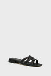 The Marc Fisher Casara Sandal is a black flat slide with a low block heel and three woven upper straps across the foot.