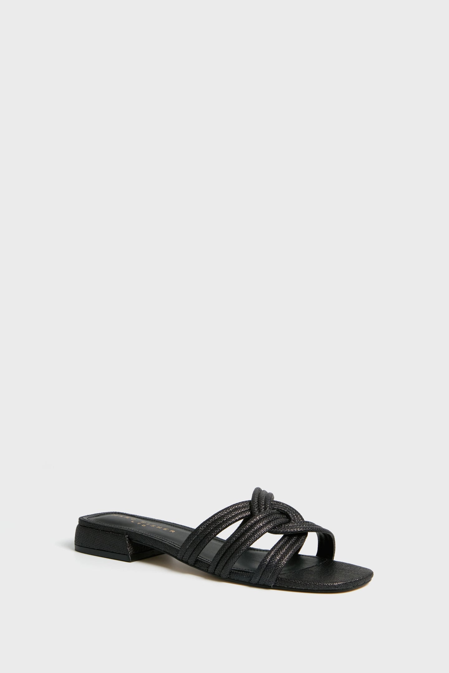 The Marc Fisher Casara Sandal is a black flat slide with a low block heel and three woven upper straps across the foot.