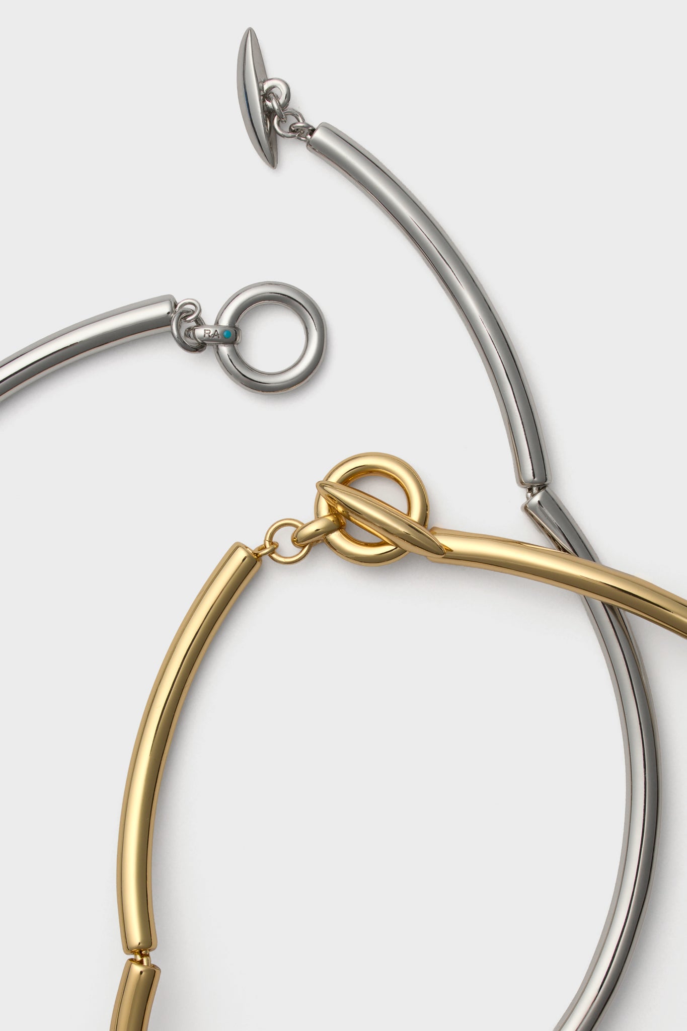 Shiny Gold and Dark Silver Tubular Collar Necklace Set of Two featuring classic, polished metal links with toggle-bar clasps, offering an effortless, high-end style for any occasion.