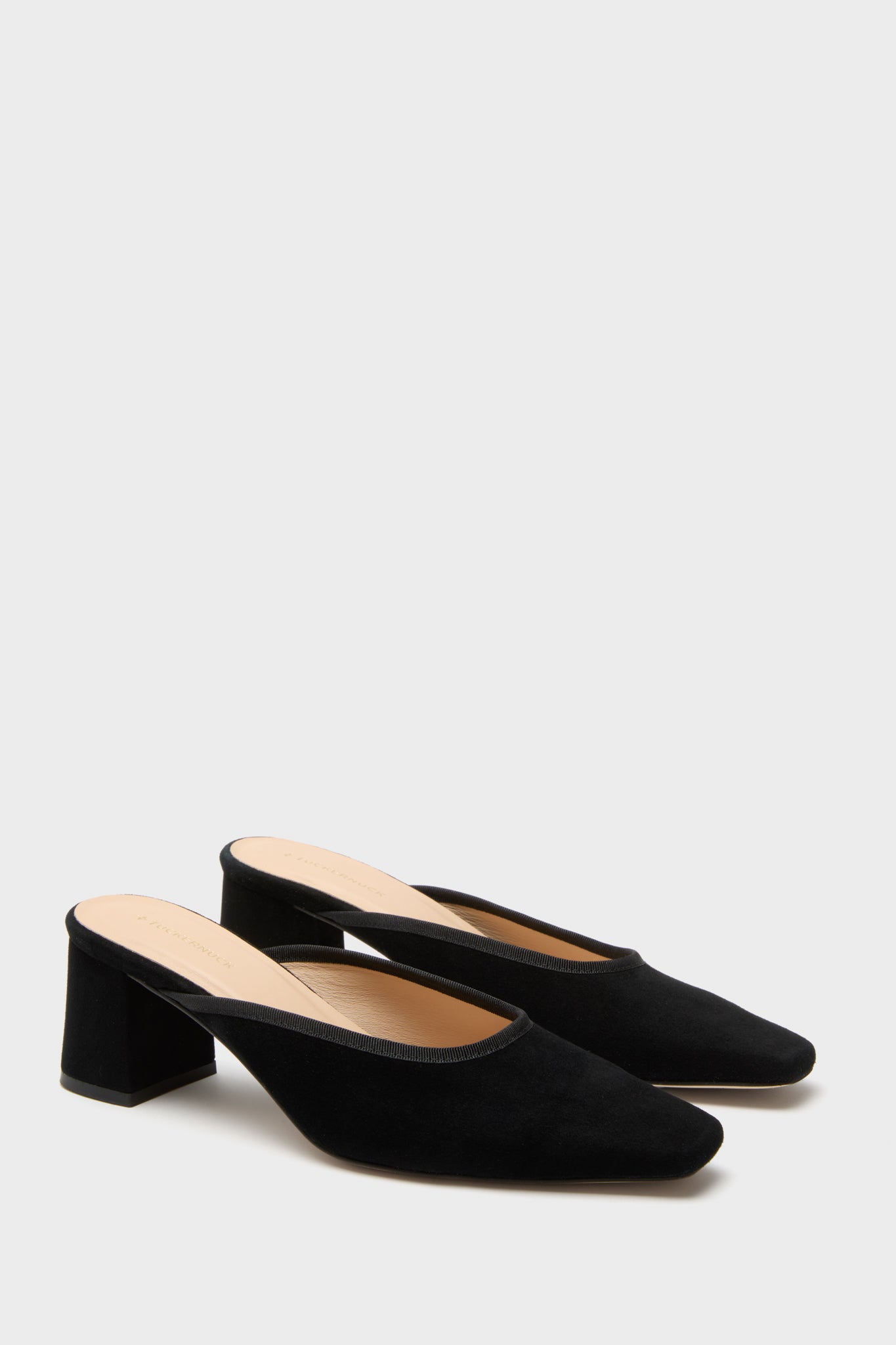 Black Suede Tilda Mules: Classic slip-on heels with an effortless mule silhouette, featuring an elongated square toe and fun, comfortable block heel, exuding high-end European craftsmanship.