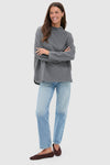 Woman in a Slate Gray Bowie Popover showcasing its classic, effortless style with a swing shape and batwing sleeves, embodying fun and high-end fashion.