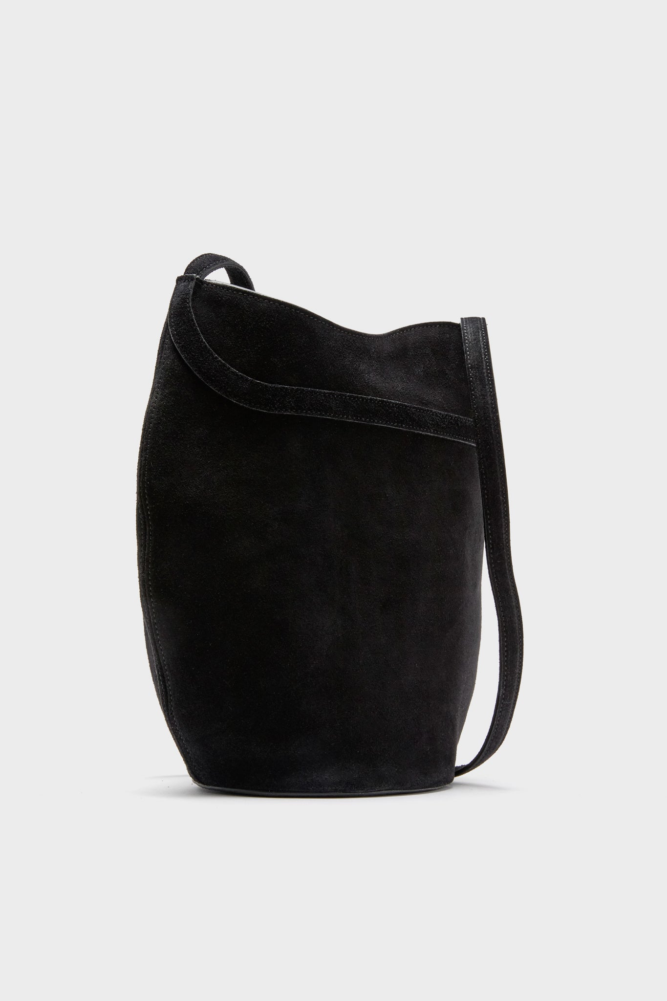 Black Suede Belted Bucket Bag with adjustable strap, magnetic snap closure, and gold-tone hardware, offering an effortless, high-end, and classic style for versatile wear.