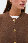 Close-up of a woman in the Brown Morgan Cardigan, showcasing its classic and effortless style with high-end gold-tone buttons, perfect for a fun, polished look.