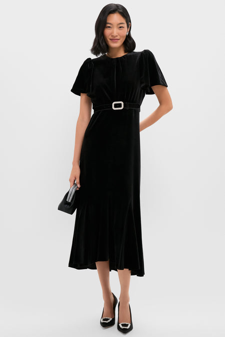 Woman in a classic black velvet dress wearing the Black Velvet Waist Belt, featuring a jewel-encrusted buckle, epitomizing an effortless, high-end style.