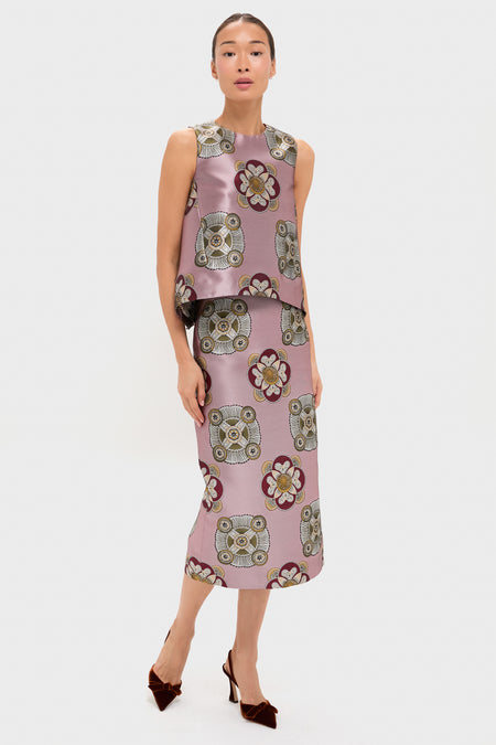 A woman wears a La DoubleJ sleeveless jacquard top with a loose trapeze silhouette and matching midi skirt, both in a geometric floral pattern of pink, cream, and brown, styled with dark pointed heels.