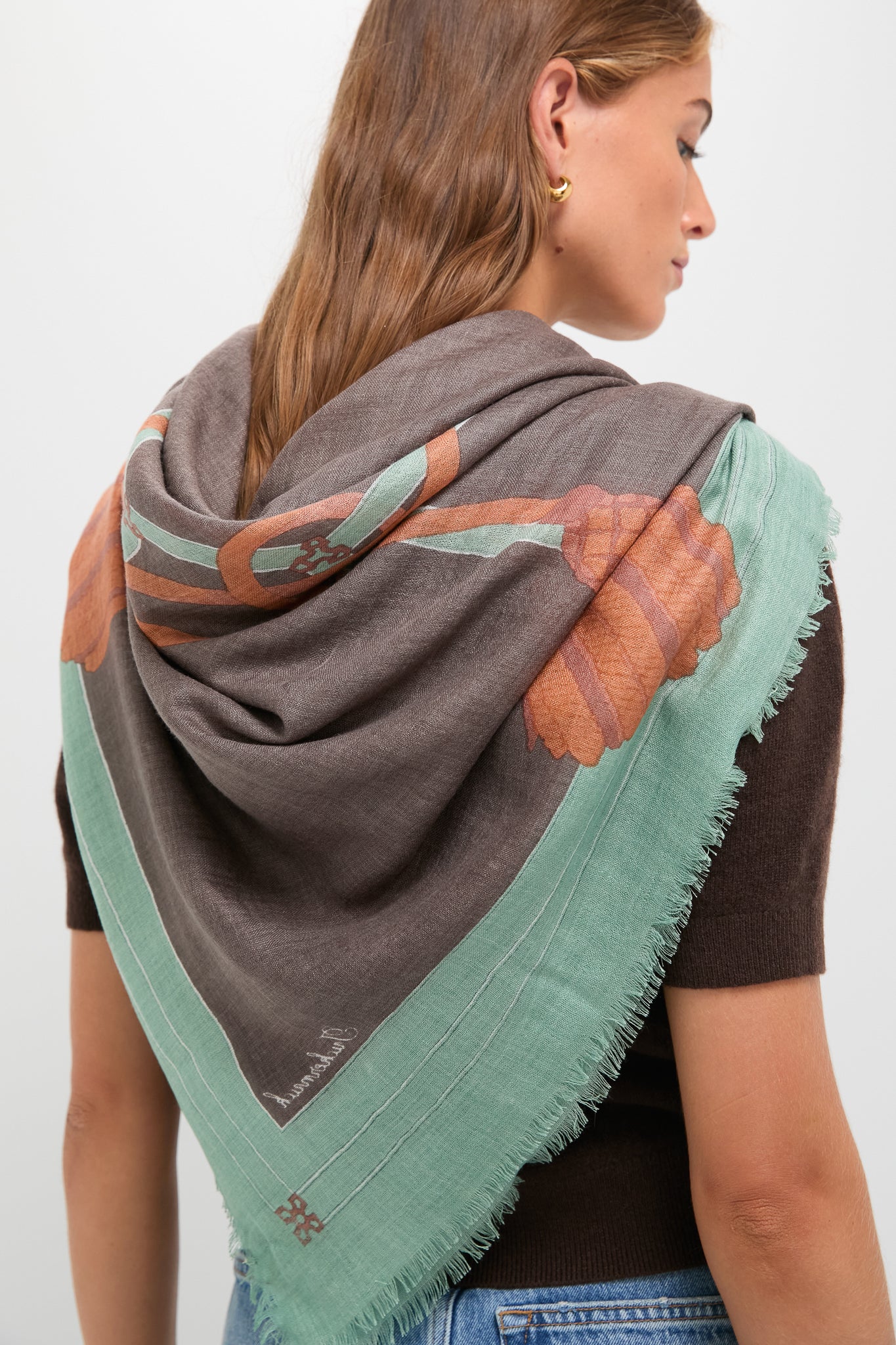 French Tassel Silk Cashmere Blend Large Scarf draped effortlessly over shoulders, showcasing a classic and high-end design with fringe edges and a tonal botanical motif.