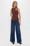 Model wearing the classic, high-end Brown Faux Suede Franz Top with faux pockets and high neckline, paired effortlessly with high-waisted jeans and heels for a fun, stylish look.