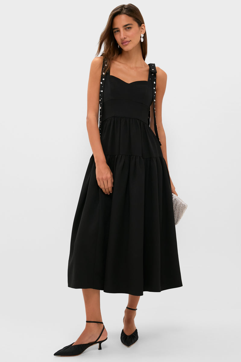 Model in a classic, high-end Black Embellished Agnes Maxi Dress with bow-tied straps, corset waist, and full skirt; styled effortlessly with slingbacks and a fringed clutch.