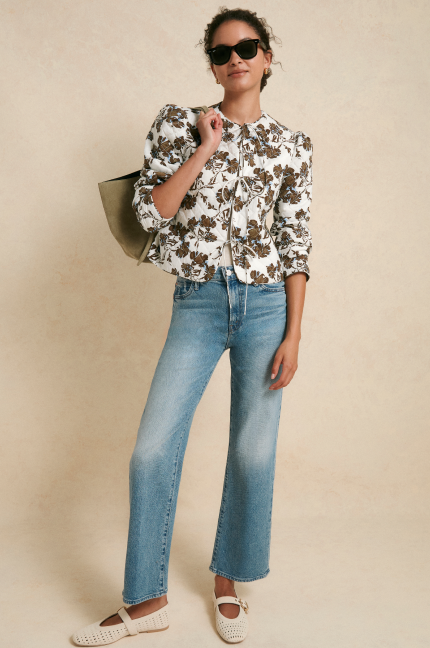 Woman in a quilted jacket and jeans. 