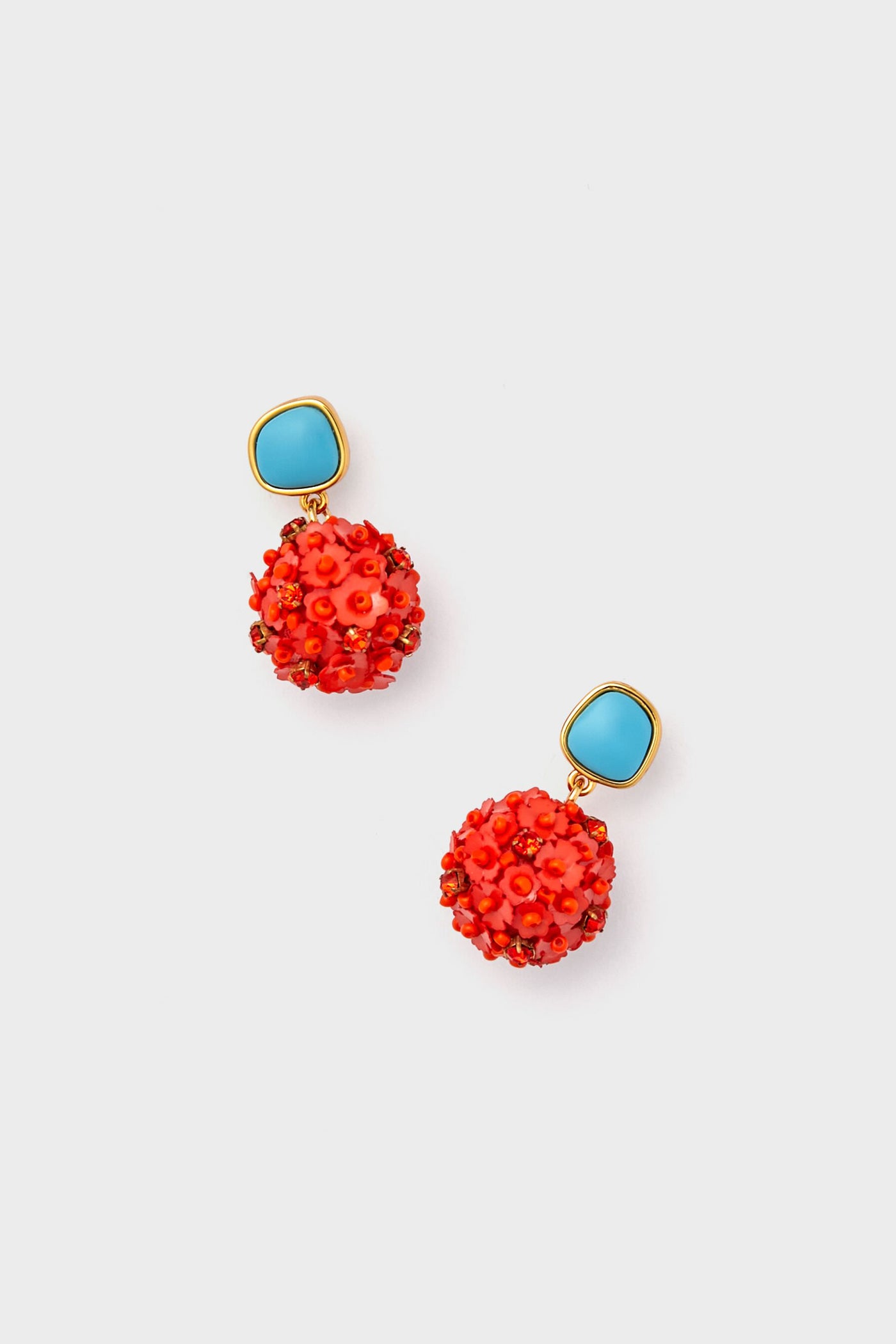 Handcrafted Lizzie Fortunato earrings with blue, gold-edged studs and round, textured red-orange floral dangles. Elegant gold-plated accents add a stylish touch to this unique jewelry piece.