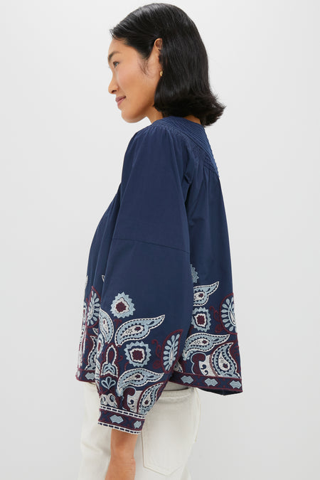 Navy Embroidered Lucia Blouse featuring classic long puff sleeves, intricate paisley embroidery, and a fun, effortless style that pairs perfectly with denim for a high-end look.