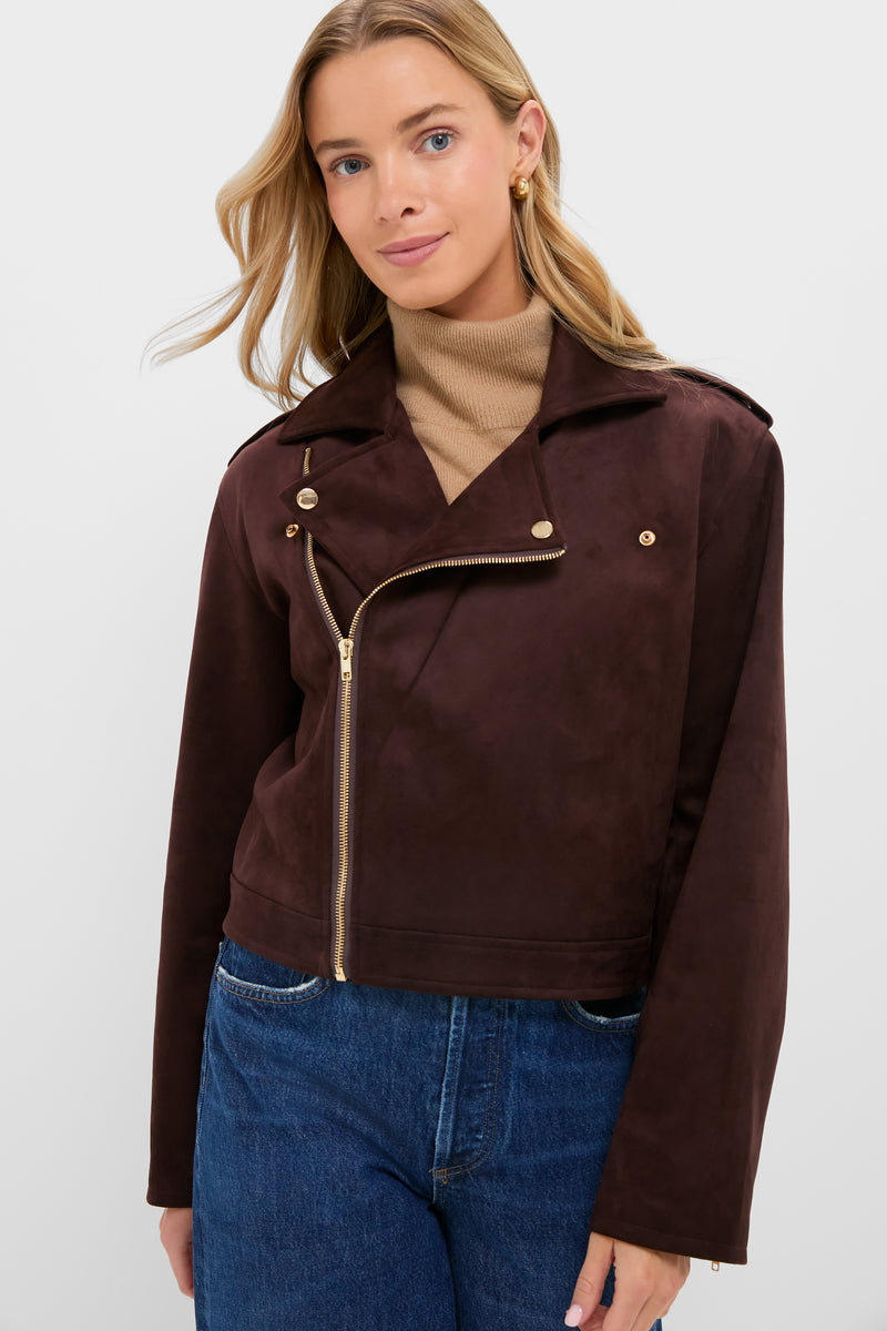 Young woman models the classic Chocolate Faux Suede Bristol Jacket with gold hardware over a tan turtleneck, embodying effortless, high-end style with a fun, chic vibe.