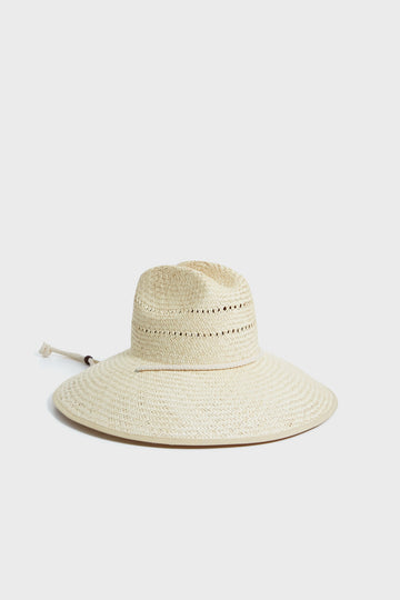 The Vista Hat White by Lack of Color is a wide-brimmed sun hat featuring woven straw, decorative ventilation holes, and an adjustable chin cord.
