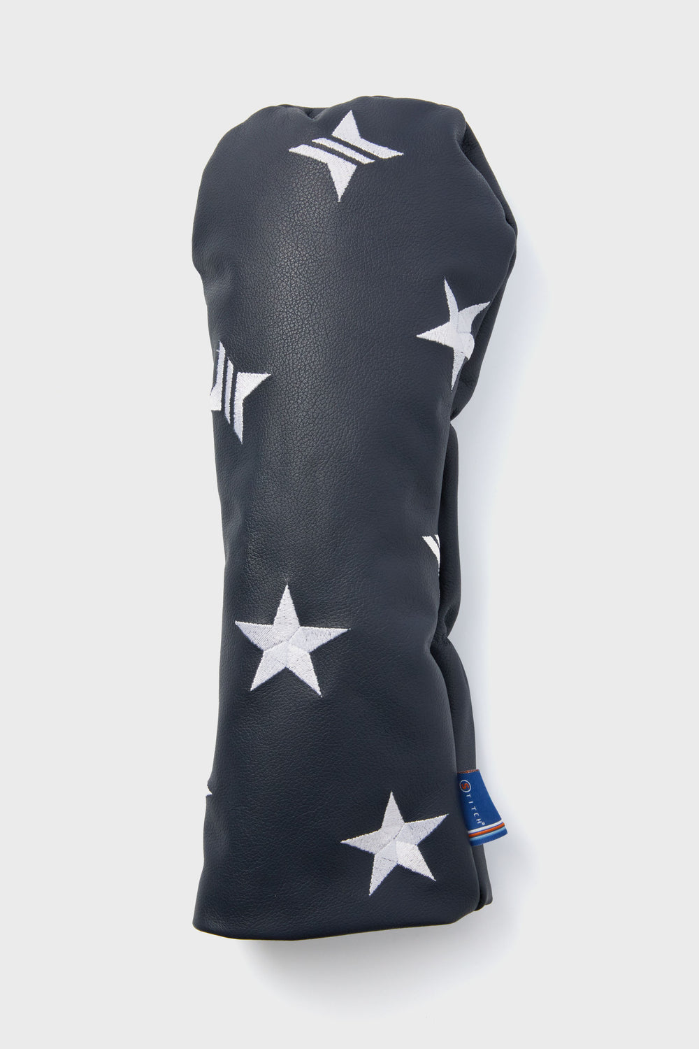 Tuckernuck x Stitch Golf navy leather head cover with white star patterns and a small blue tag near the bottom.