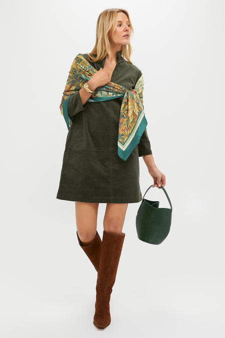 Woman models a classic, effortless autumn look with the High Polish Gold Lydia Cuff, enhancing her fun, high-end style featuring a corduroy dress and suede boots.