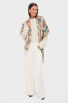 Woman models Garden Scrollwork Silk Cashmere Blend Large Scarf, effortlessly draped over creamy sweater and ivory trousers, showcasing its classic, high-end botanical print.