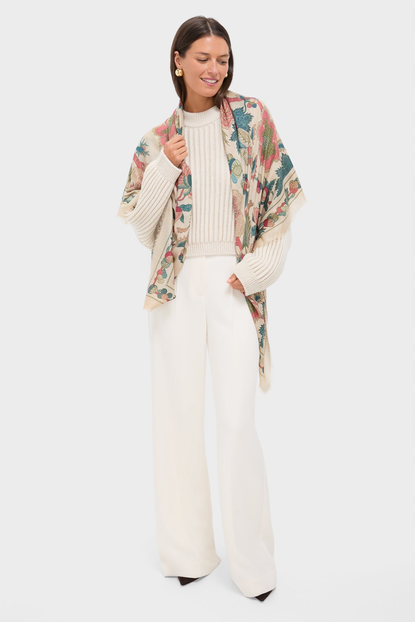 Woman models Garden Scrollwork Silk Cashmere Blend Large Scarf, effortlessly draped over creamy sweater and ivory trousers, showcasing its classic, high-end botanical print.