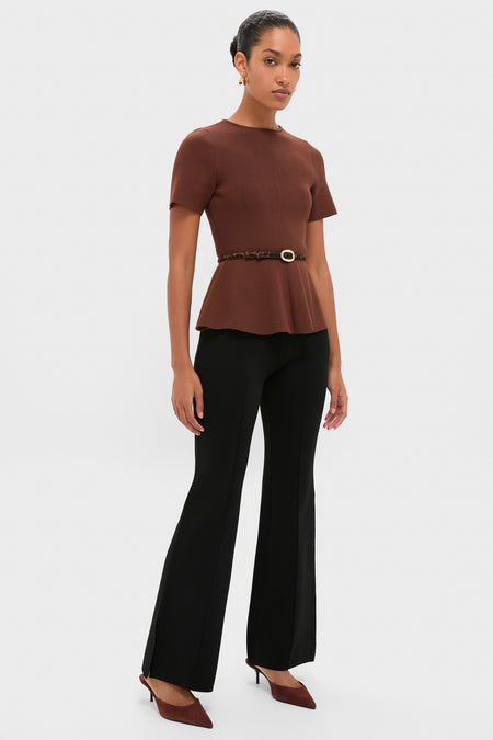 Model wearing Black Hana Pull On Full Flare pants, styled with a brown knit top and leopard belt, showcasing an effortless, high-end office-to-evening look.