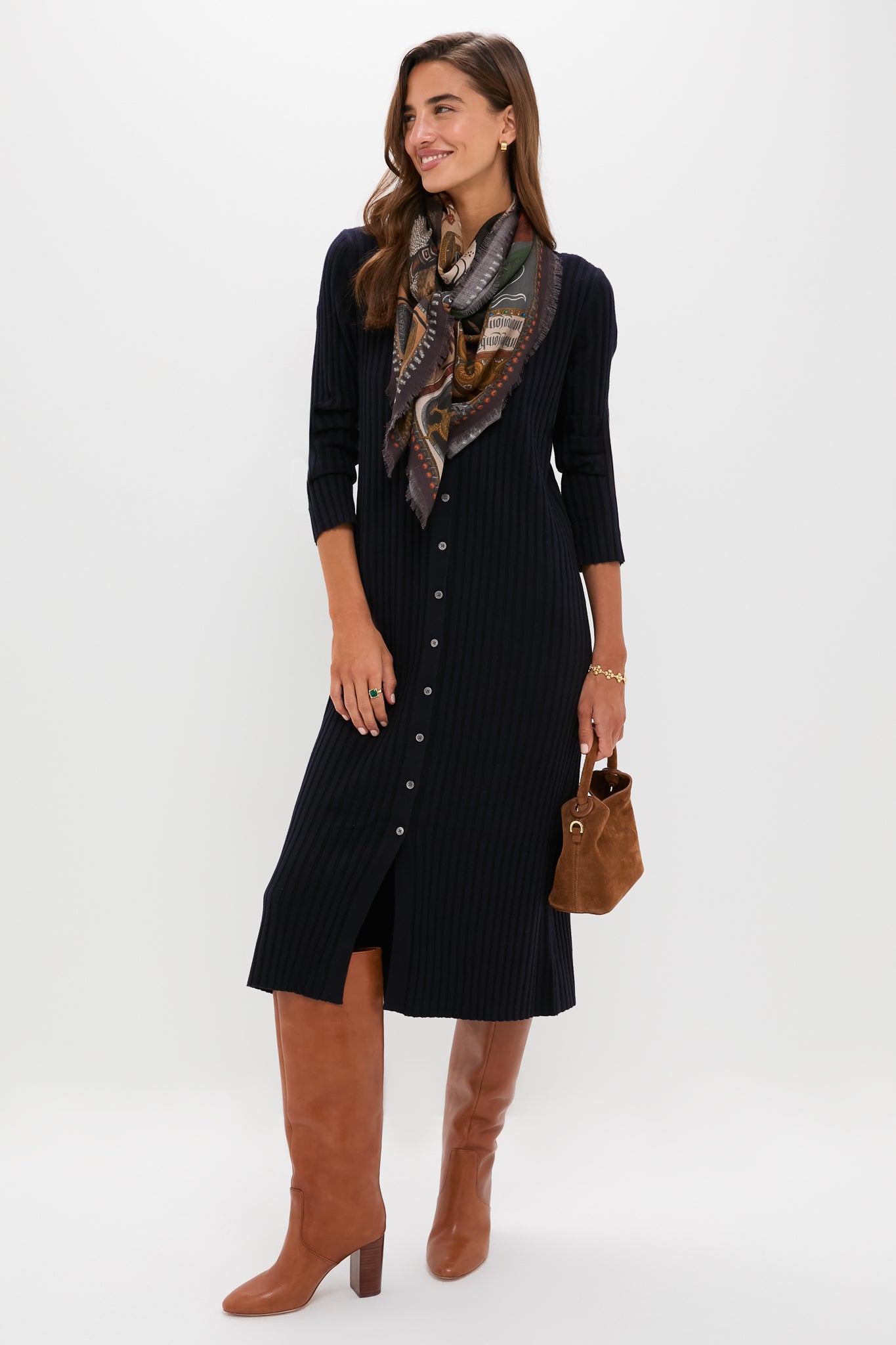 Woman models classic, effortless smart-casual attire featuring the Berry Clover Linear Bracelet, 7+2 - Gold, embodying high-end, fun style with delicate gold clovers.