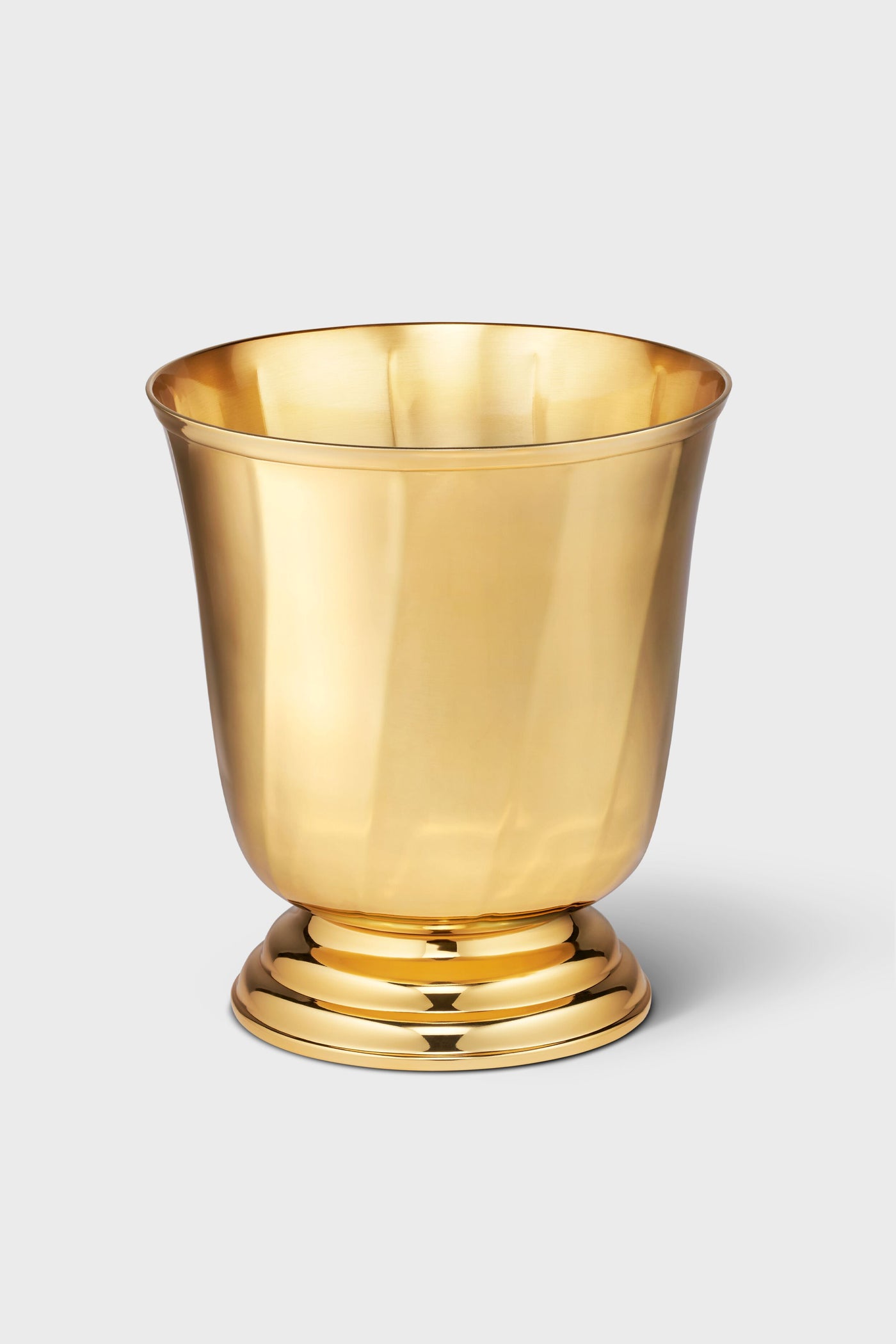 The AERIN shiny gold-colored stainless steel bowl features a wide rim and round base, making it perfect as an ice bucket for your home bar.