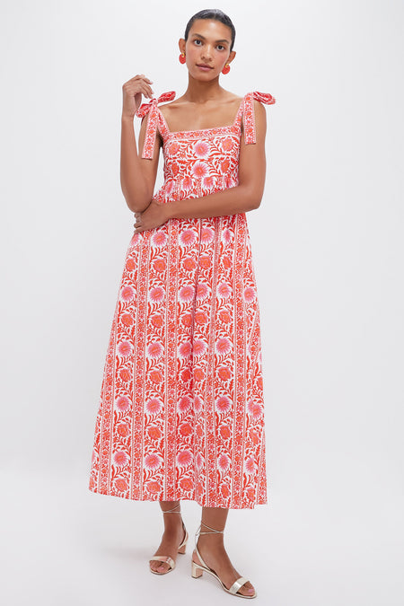 A woman wears a Pink City Prints red and white block-printed maxi dress with tie straps, paired with matching earrings and open-toed heels.