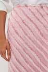 Soft Pink Shimmer Stripes Milan Midi Skirt with diagonal glittery texture, showcases classic elegance and effortless style, perfect for fun, high-end gatherings.