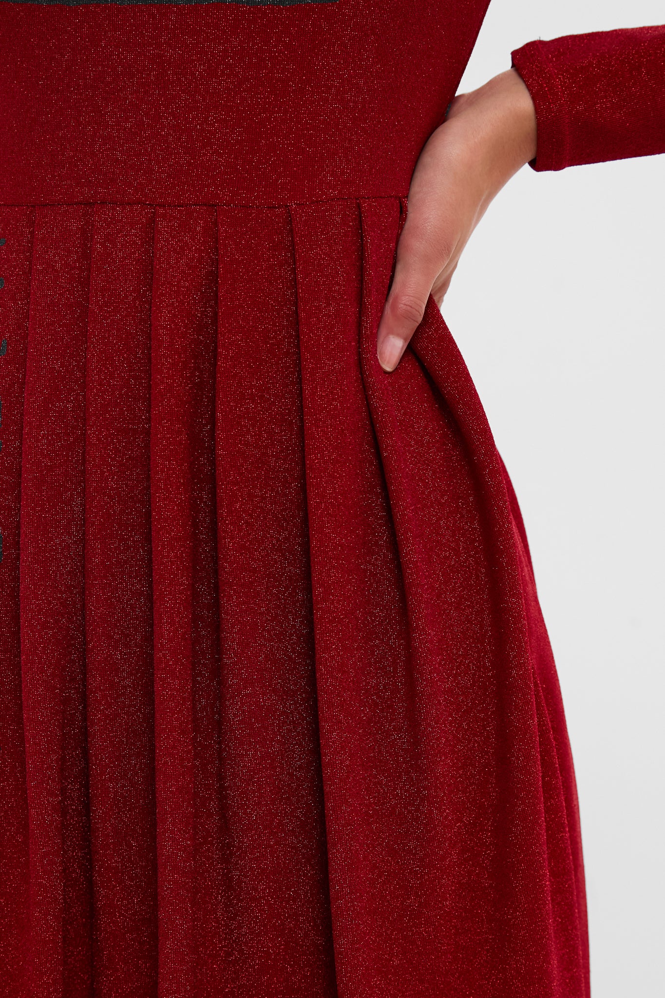 Red Shimmer Pleated Bale Mini Dress with classic pleats, a fitted waistband, and an effortless shimmer. Features a fun hidden pocket and high-end metallic detail.