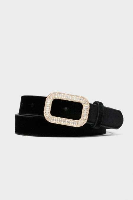 Tuckernuck Accessories presents a black velvet waist belt with an adjustable rectangular gold-tone buckle embellished with clear rhinestones.