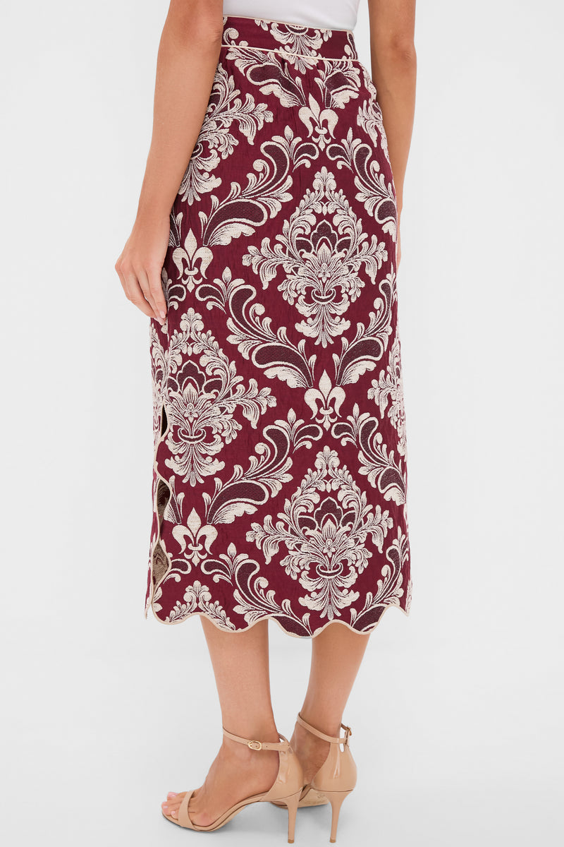 Woman modeling a classic Blush Pink and Burgundy Bicolor Jacquard Waves Midi Skirt with a fun damask pattern, scalloped hem, and subtle side slit for an effortless high-end look.