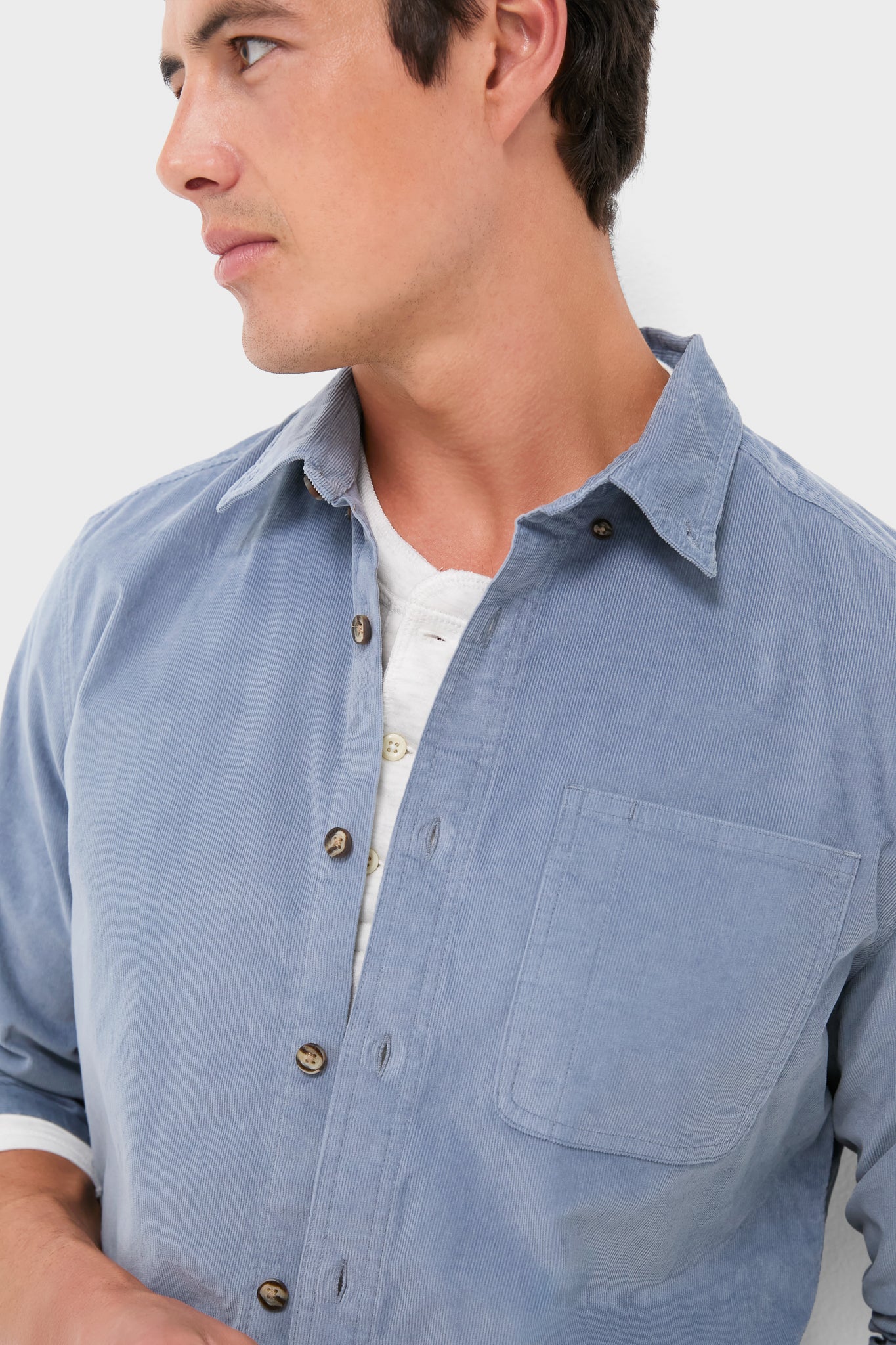 Effortlessly cool, the Maritime Wilder Stretch Corduroy Shirt is modeled open over a white henley, showcasing its classic, versatile design with a single chest pocket.