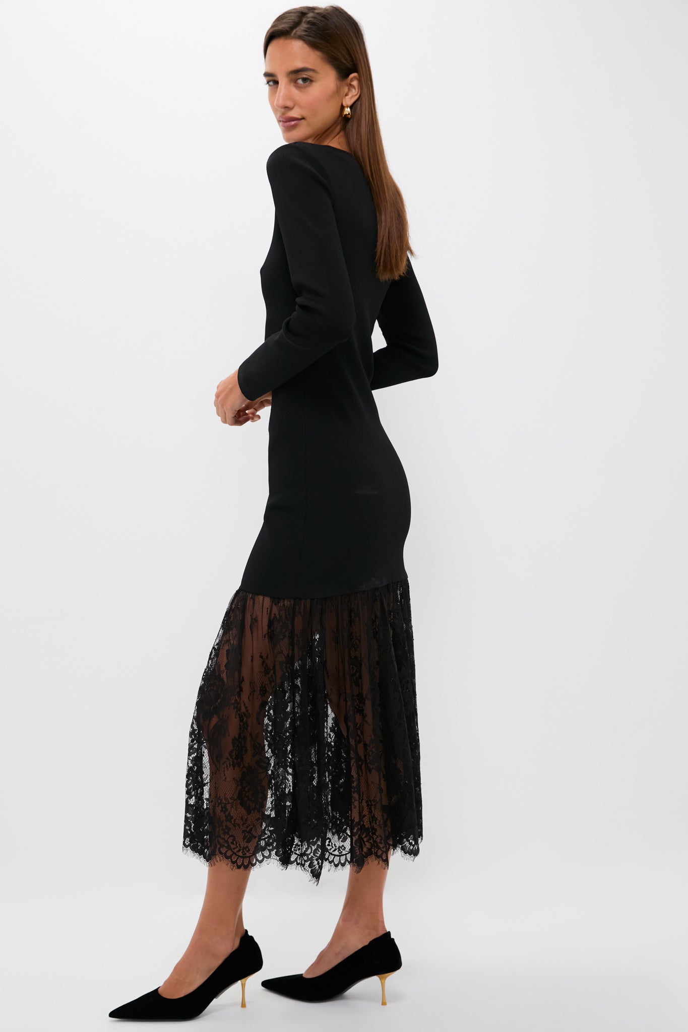 Woman in profile wearing the classic Black Knit Giavanna Maxi Dress with an effortless knit bodice and fun, high-end sheer lace skirt, exuding confidence and glamour.