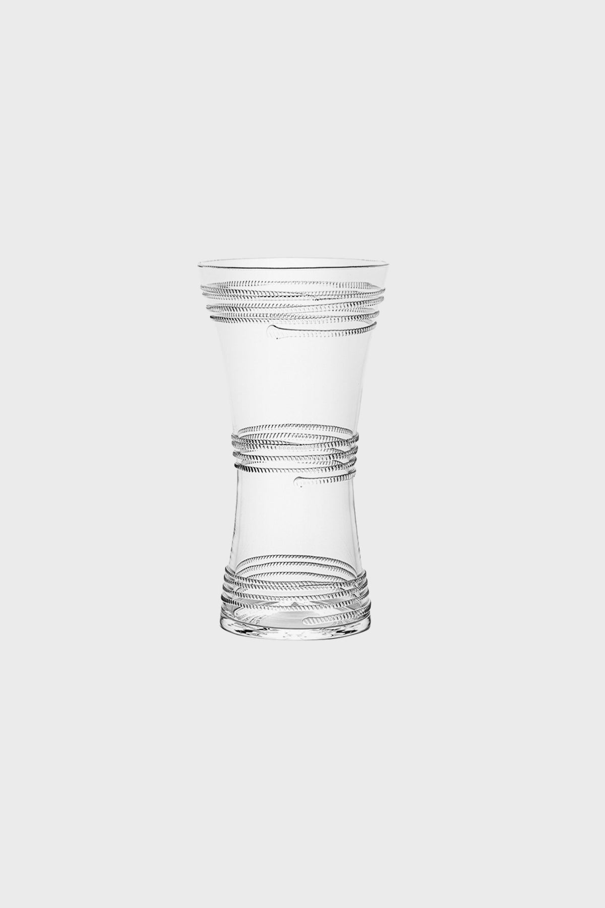 A clear glass vase by Juliska, featuring an hourglass shape and horizontal spiral grooves at the top, middle, and base—a striking decorative piece.