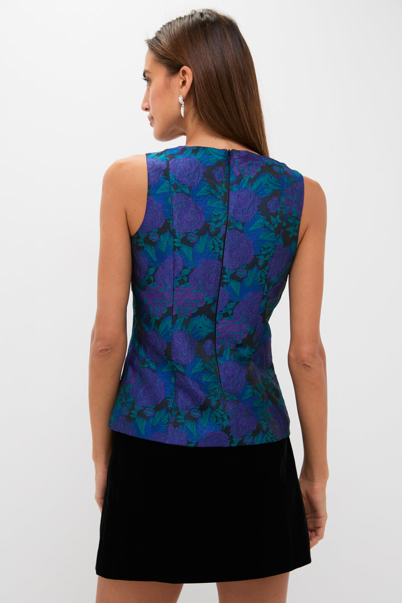Woman wearing Navy & Indigo Jacquard Floral Jacquard Ivy Blouse, a classic, sleeveless, fitted top with back zip, styled with a black mini skirt for an effortless, high-end look.