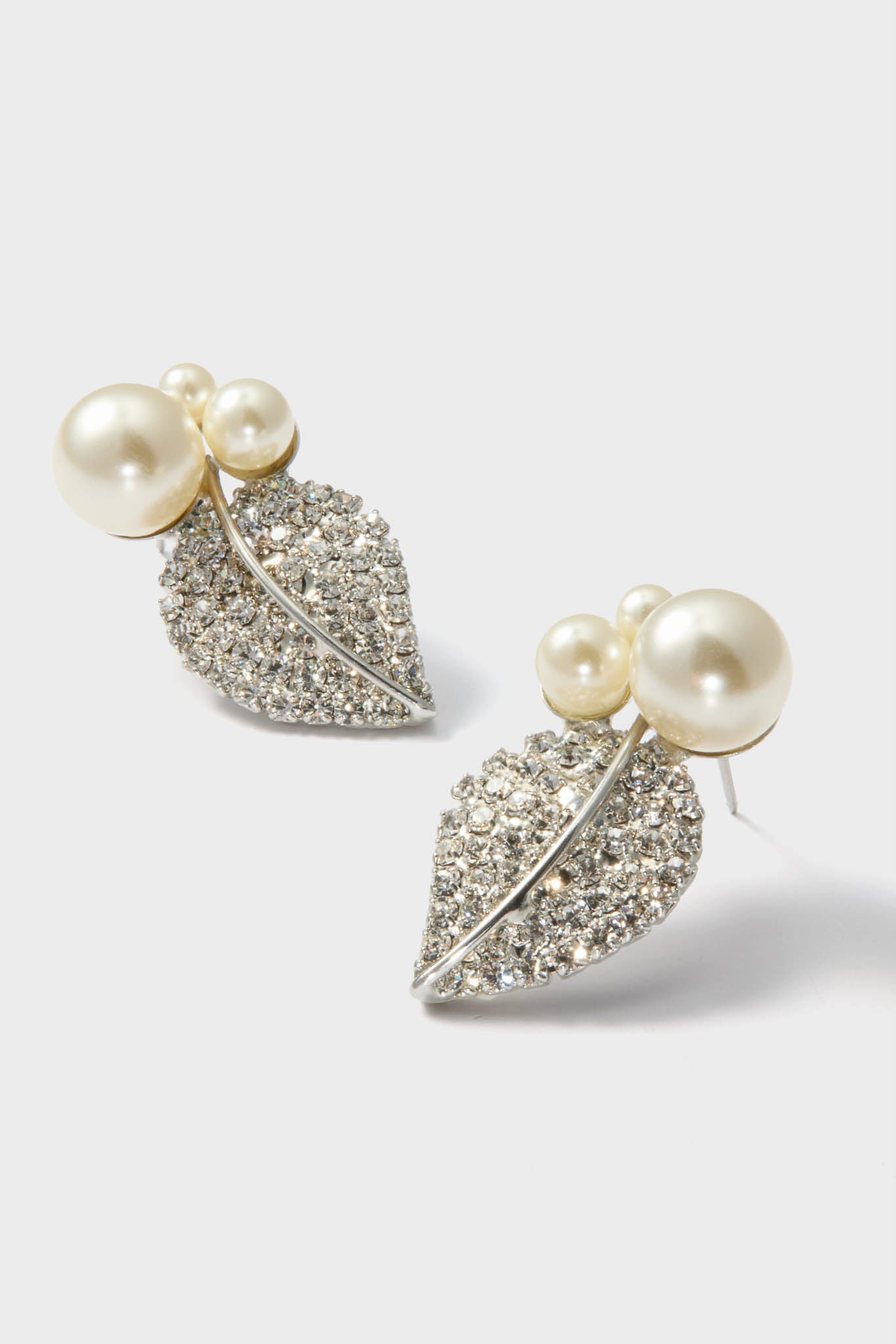 Crystal Pearl Blanca Earrings feature elegant leaf motifs with pavé rhinestones and faux pearls, combining classic charm with effortless, high-end style for a fun, refined look.