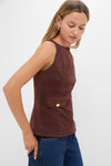 Model wearing the Brown Faux Suede Franz Top, a classic, high-end piece with a high neckline and gold button detail, paired with jeans for an effortless, fun look.