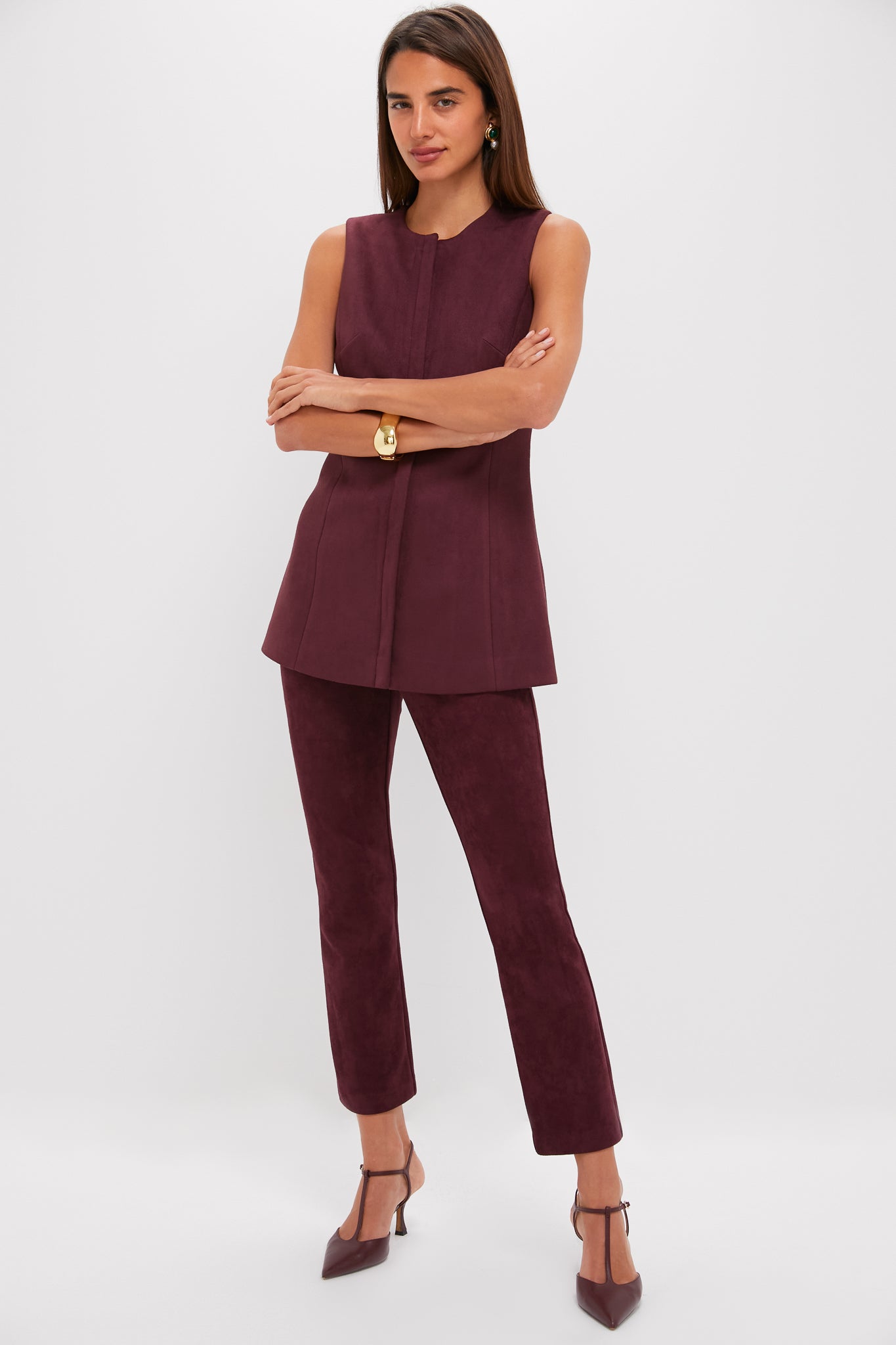 Model wearing classic, effortless Winetasting Vegan Suede Ashford Pants with high-rise, cropped kick flare hem, styled with maroon tunic and deep red T-strap heels for a high-end, fun look.