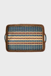 Juliska rectangular handwoven serving tray with blue, yellow, and brown stripes, side handles, and Scandinavian design, crafted from natural cane wood.