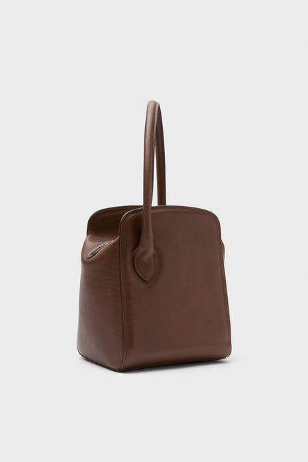 Dark Brown Leather Sporty Lady Bag with a classic, sculptural silhouette, effortless top handle, and fun charm; a high-end, versatile accessory for any occasion.