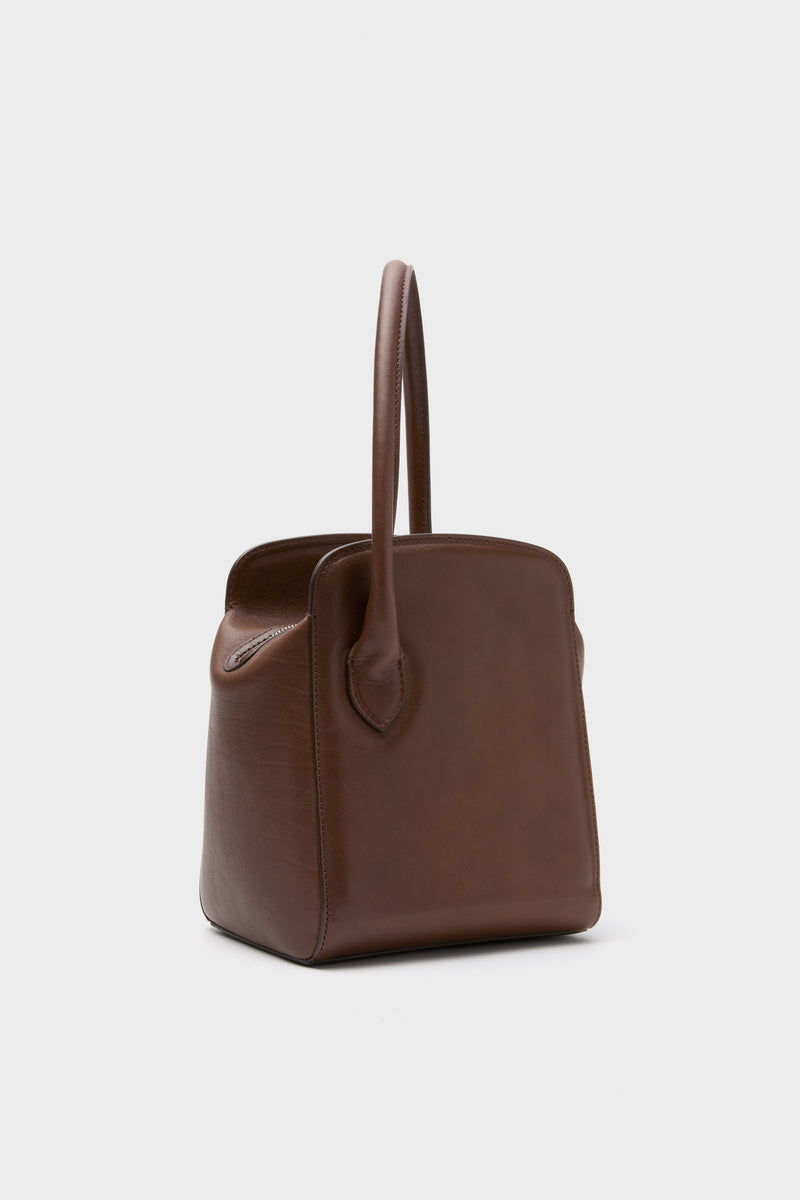 Dark Brown Leather Sporty Lady Bag with a classic, sculptural silhouette, effortless top handle, and fun charm; a high-end, versatile accessory for any occasion.