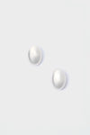 A pair of round white pearl stud earrings from Lie Studio, crafted in 18-carat gold-plated sterling silver.