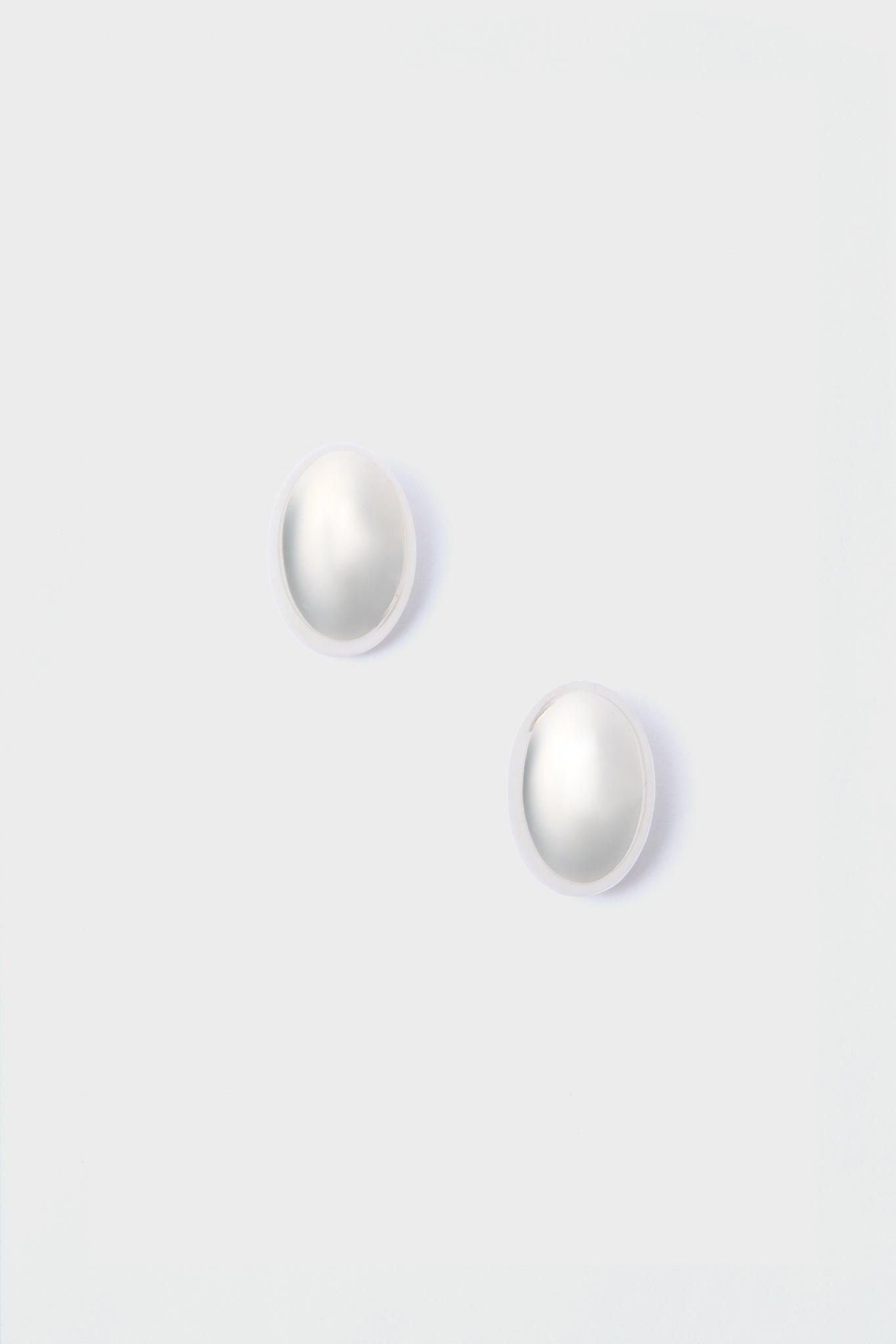 A pair of round white pearl stud earrings from Lie Studio, crafted in 18-carat gold-plated sterling silver.