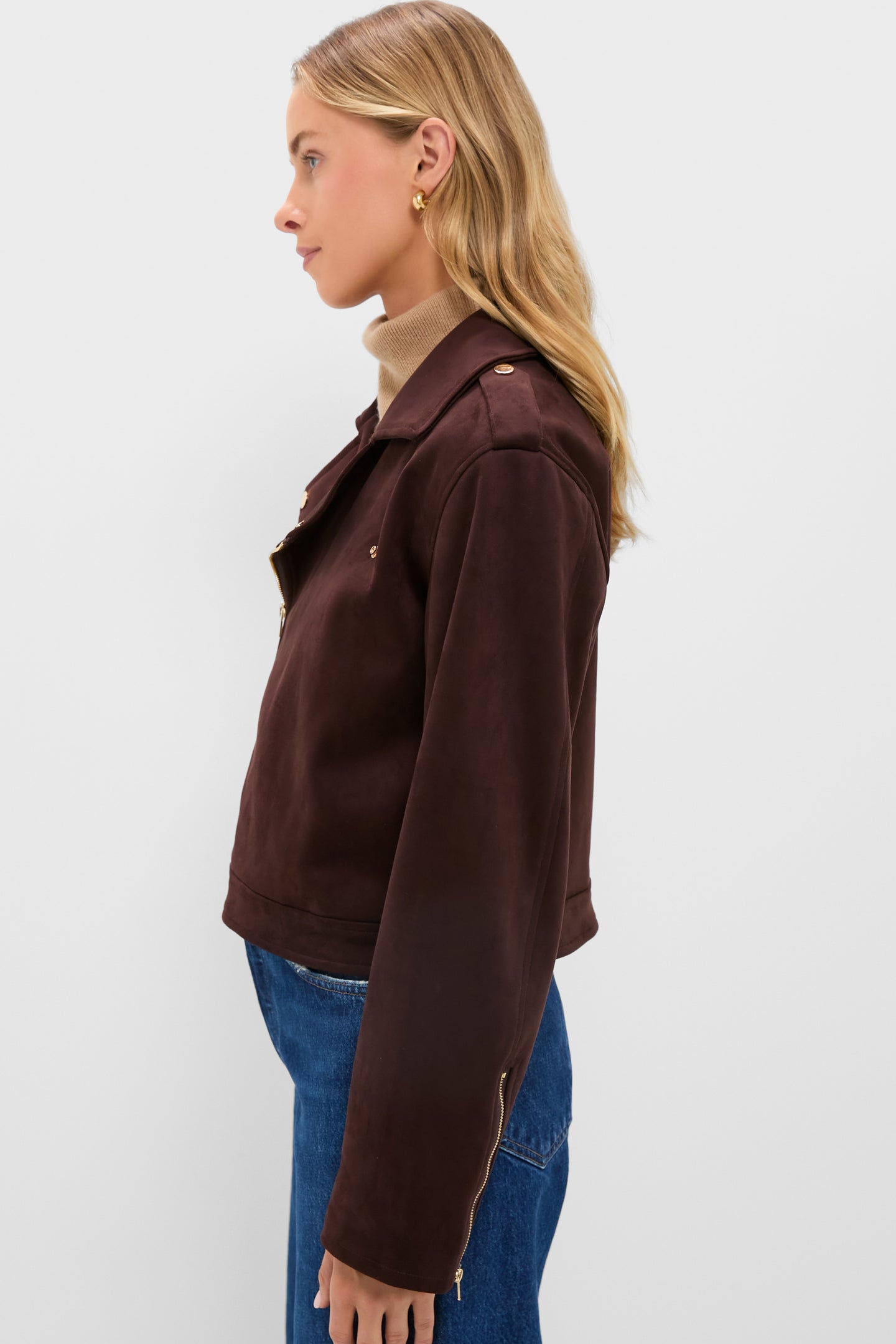 Woman wearing Chocolate Faux Suede Bristol Jacket, featuring a boxy fit, oversized notch collar, and gold hardware, styled with a turtleneck and jeans for a classic, effortless look.