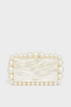 A rectangular box clutch by Cult Gaia, featuring a pearlescent finish and accented with large and small acrylic pearl beads.