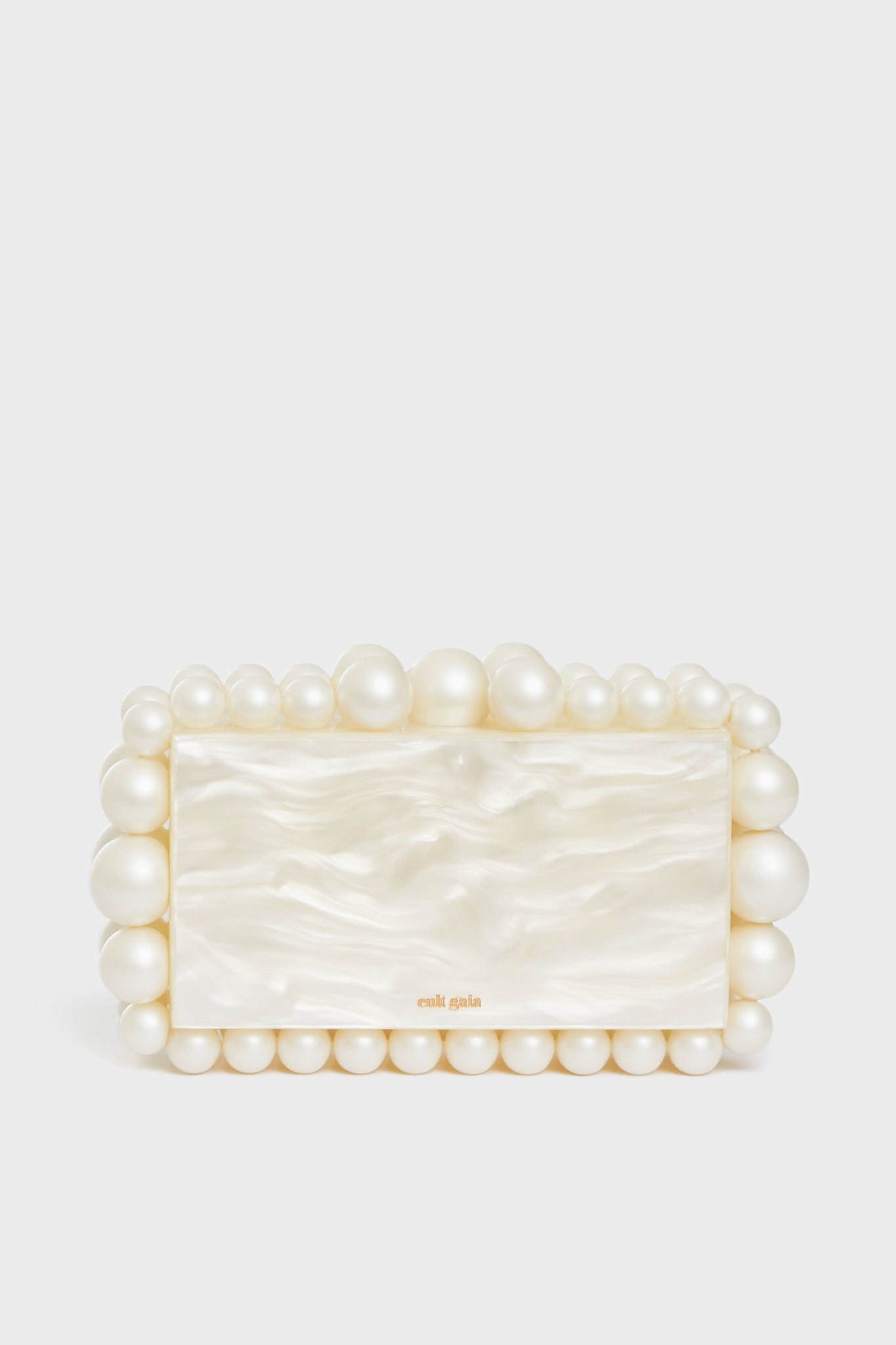 A rectangular box clutch by Cult Gaia, featuring a pearlescent finish and accented with large and small acrylic pearl beads.