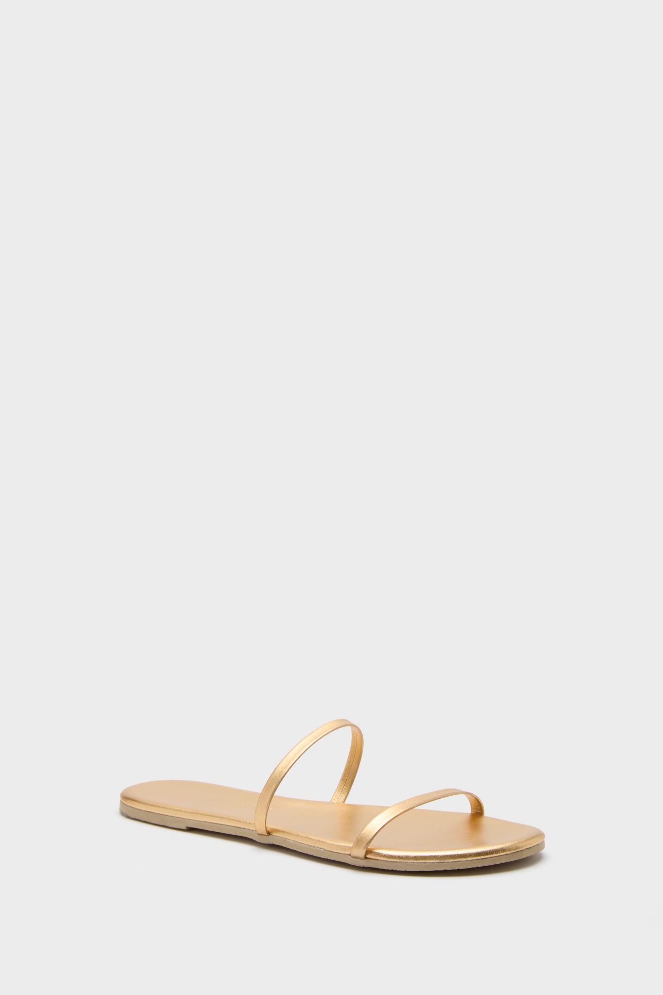 TKEES gold flat sandals feature two thin straps over the foot, making them the perfect metallic sandals for any occasion.