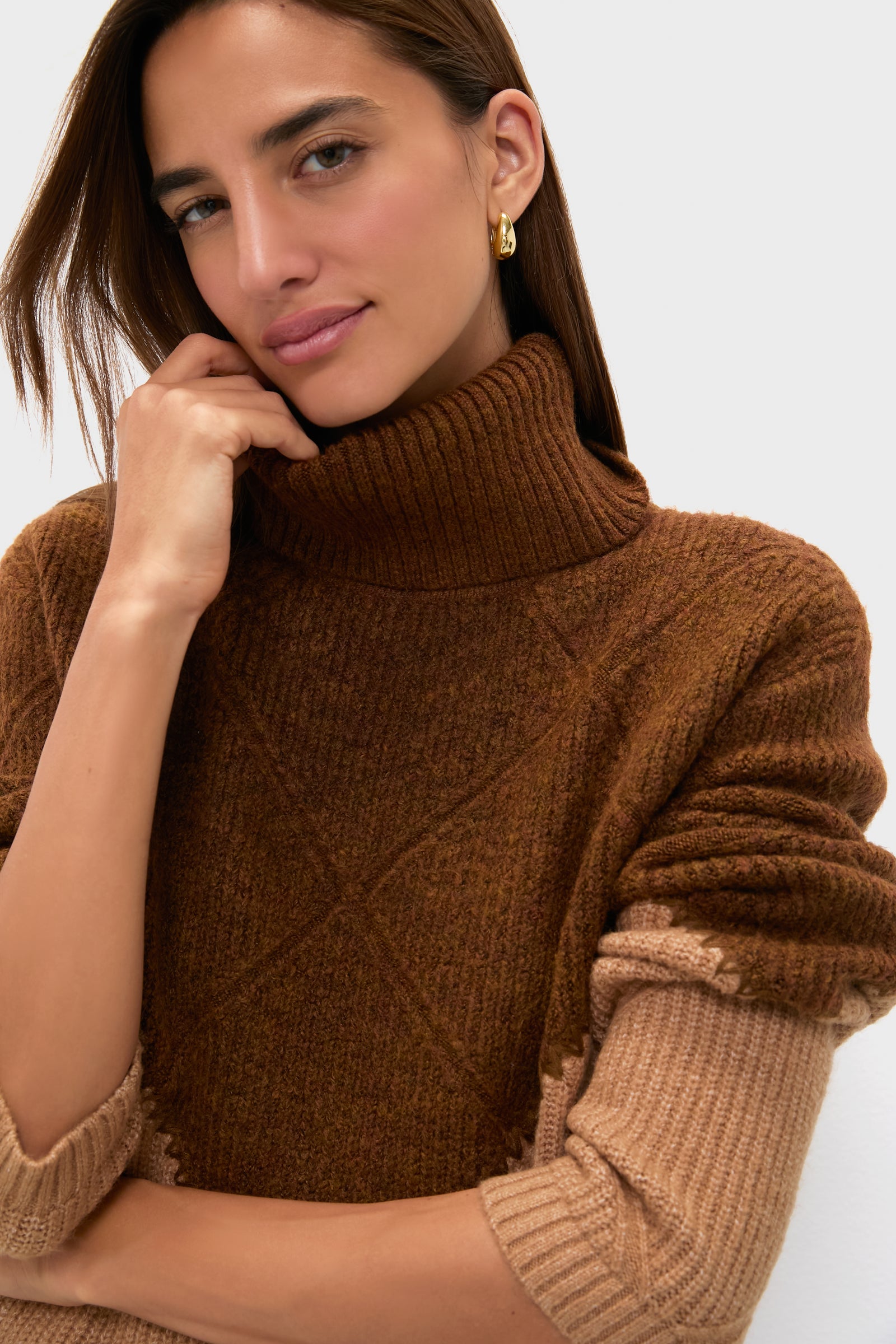 Woman wearing the Tan & Brown Diamond Demi Turtleneck, featuring a classic, effortless color block design with whipstitch detail, embodying high-end, fun style.
